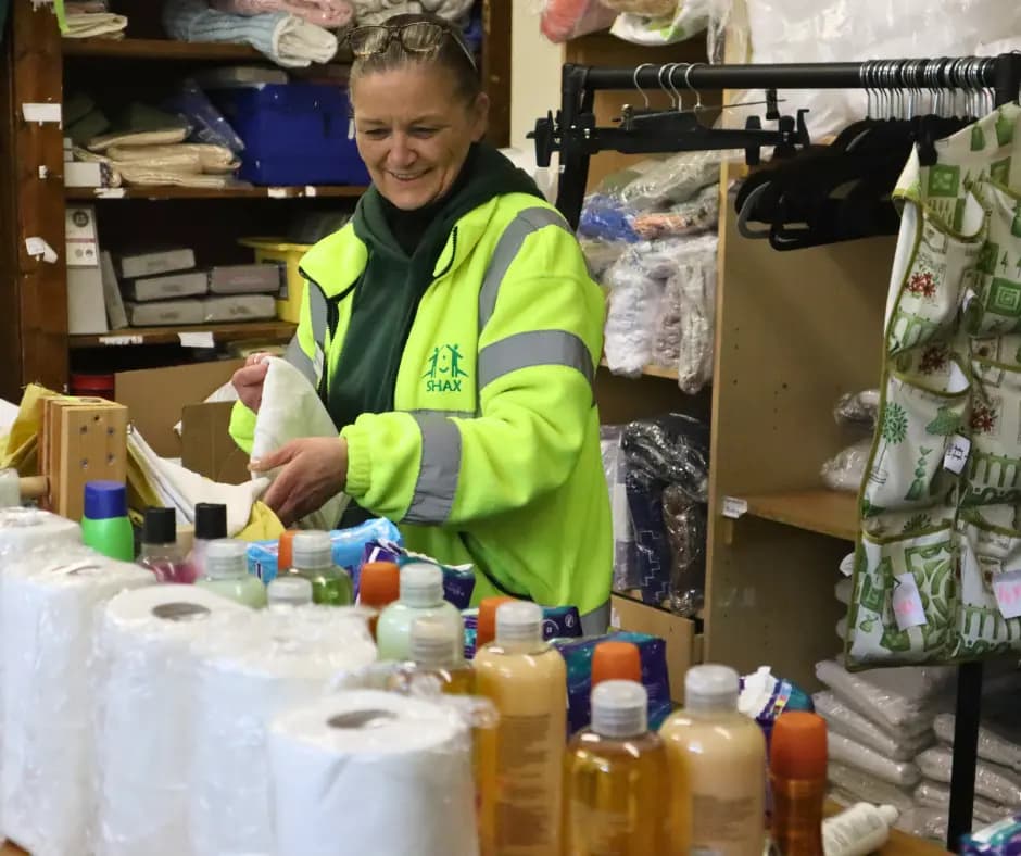 A SHAX volunteer packing toiletries and bedding for a starter pack